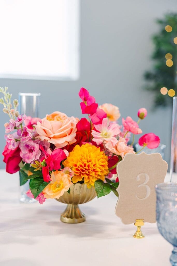 A lush compote centerpiece from the Vibrant Summertime collection completed the reception table with effortless charm and color.