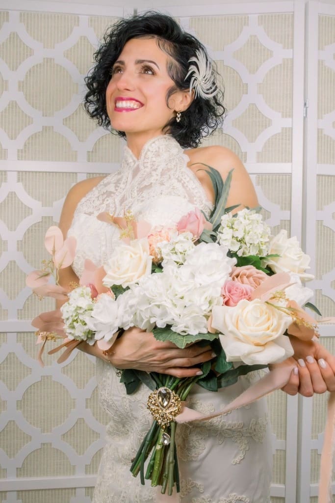 Woman happily holding elegant white florals