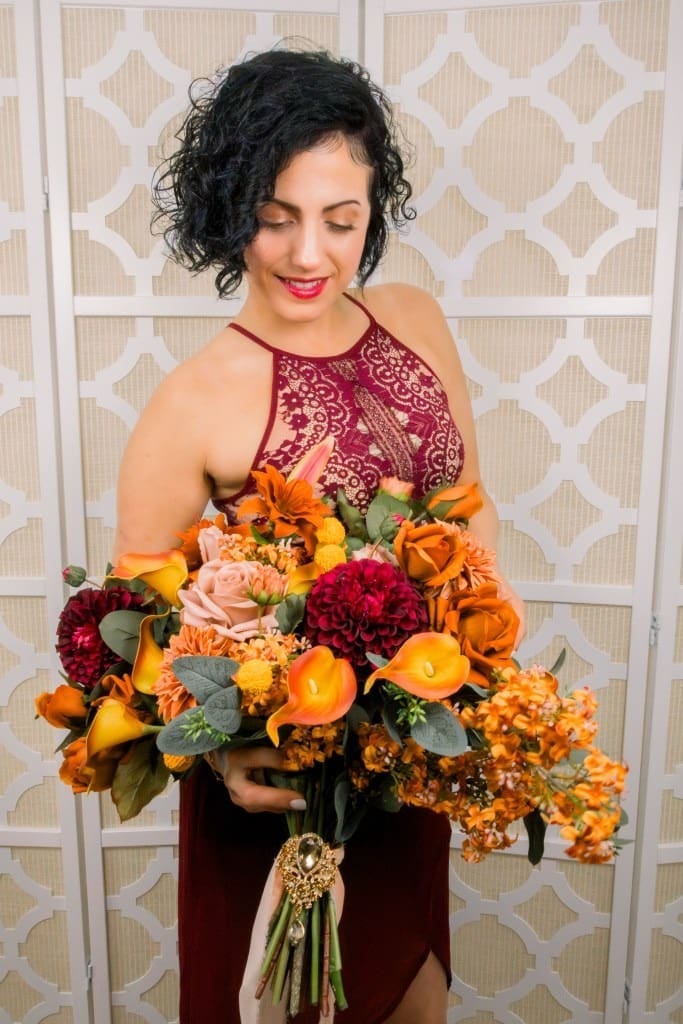 Woman in dress holding a real-touch colorful floral bouquet