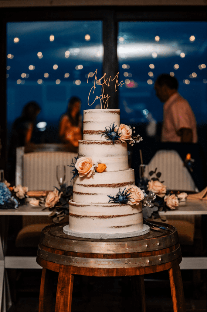 Cake with floral decor and gold topper for a Rustic Summer Wedding