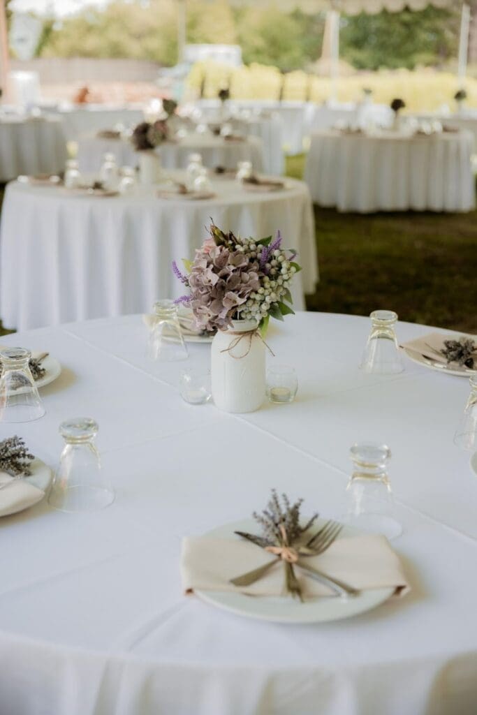 Reception table with mason jar centerpiece and lavender favors