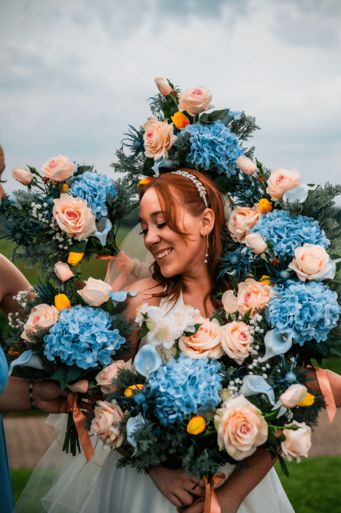Megan smiling with colorful florals surrounding her