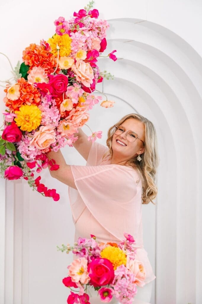 Rosemary happily holding floral decor