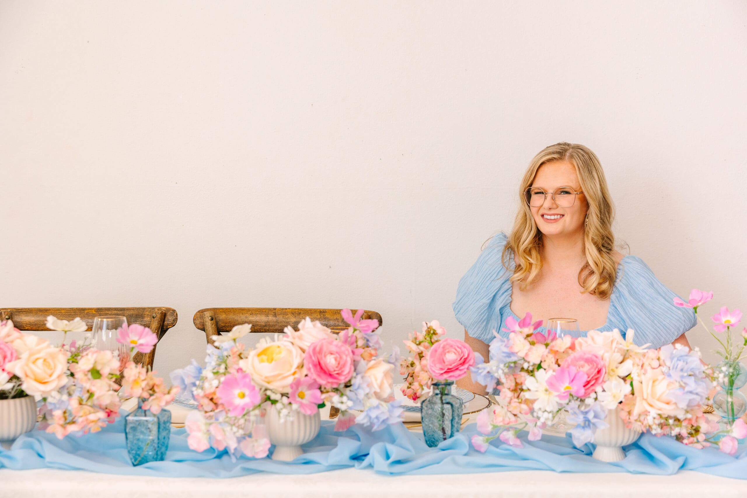 Rosemary sitting at wedding reception table set with real touch flower centerpieces